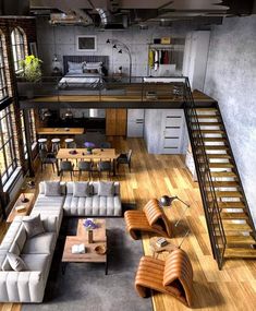 an aerial view of a living room with couches, tables and stairs leading up to the second floor