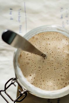 there is a cup of coffee with a spoon in it