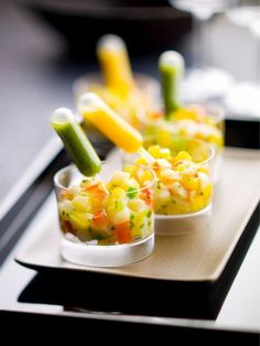 three small cups filled with food on top of a tray