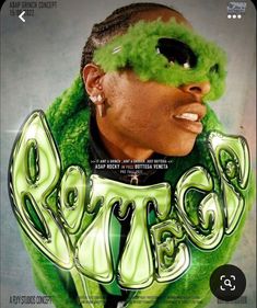 a man with green hair and sunglasses on top of his head, in front of a poster