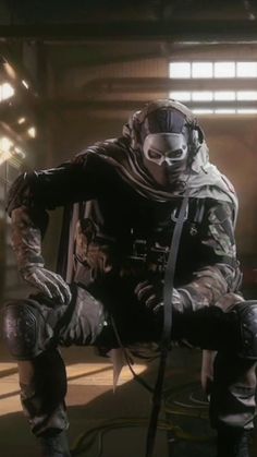 a man in a space suit sitting on the ground