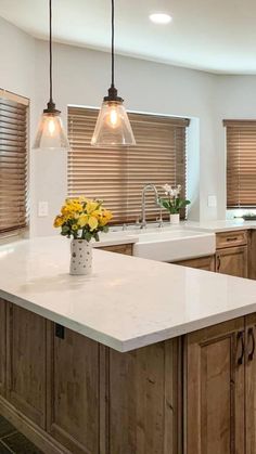 a kitchen with an island and two pendant lights