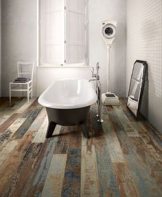 a bath tub sitting on top of a wooden floor