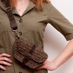 a woman wearing a brown dress holding a purse