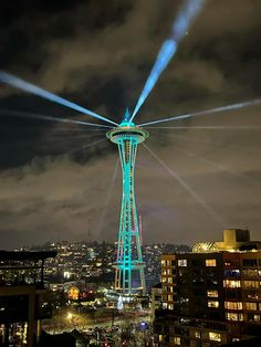 the space needle is lit up with blue lights