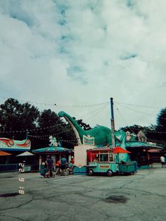 an amusement park with people riding on the rides