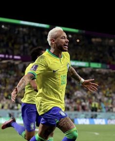 the soccer player is running after the ball in front of him and celebrating his team's victory