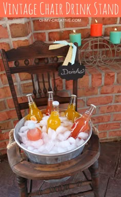 a bucket filled with drinks sitting on top of a wooden chair