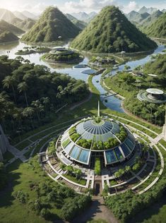 an aerial view of a circular building surrounded by greenery and mountains in the background