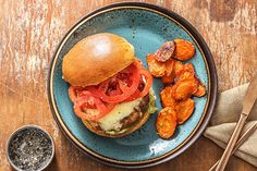 a plate with a burger and some fried potatoes