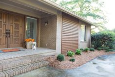 the front entrance to a home with brick steps