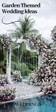 an outdoor wedding venue with flowers and greenery around the pool, surrounded by palm trees