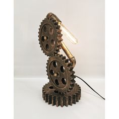 a lamp made out of gears on a white background