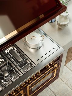 a stove top oven sitting next to a counter with pots and pans on it