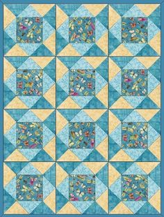 a blue and yellow quilt with many squares