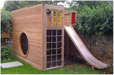 a small wooden play structure with a slide