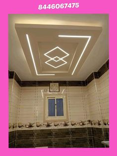 the ceiling in this bathroom has been decorated with white tiles and decorative lighting above it