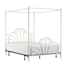 a white metal bed frame with four posts