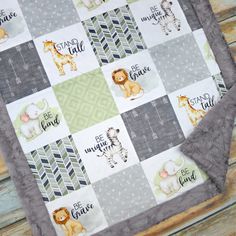 a baby quilt with animals and words on it