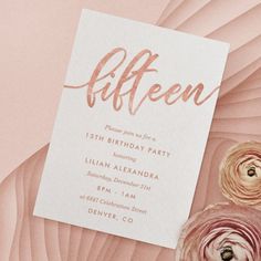 a pink and white birthday party card with flowers on it, next to an envelope that says fifteen