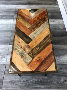 a coffee table made out of wooden planks on top of a hard wood floor