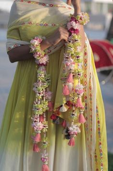 the woman is wearing a green dress with flowers on it