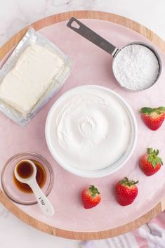 the ingredients to make strawberry shortcakes are displayed on a pink platter with strawberries