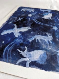 a blue and white painting with animals in the night sky on it's surface