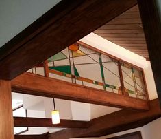 the inside of a building with stained glass and wood trimmings on the ceiling