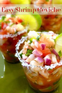 three small cups filled with food on top of a green table next to cucumbers