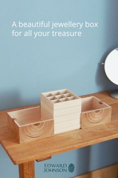 a beautiful jewelry box for all your treasures is displayed on a wooden table in front of a blue wall