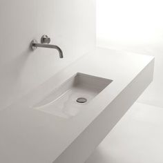 a white bathroom sink sitting on top of a counter