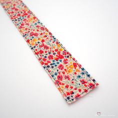 a flowered tie laying on top of a white table