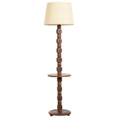 a wooden floor lamp with a white shade on the top and bottom shelf below it