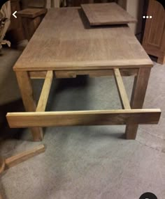 three wooden tables sitting next to each other on top of a carpeted room floor