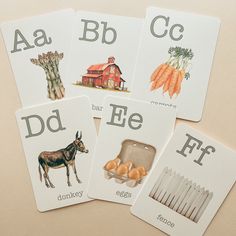 four cards with pictures of animals and letters