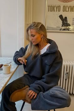 a woman sitting on a chair in front of a table