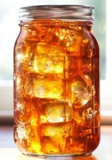 a mason jar filled with ice cubes on top of a table