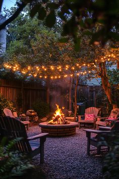 Backyard with a fire pit surrounded by Adirondack chairs and string lights hanging above. Creative Backyard Ideas, Backyard Decor Ideas, Rustic Outdoor Spaces, Landscaping Small Backyard, Backyard Goals, Creative Backyard, Comfortable Outdoor Furniture, Vertical Succulent Gardens, Affordable Backyard Ideas