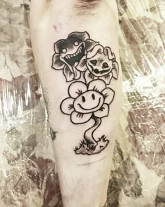 a person with a tattoo on their leg that has flowers in the shape of a flower