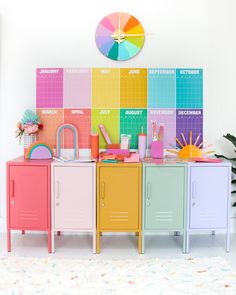 the colorful lockers are next to each other in front of a wall with calendars on it