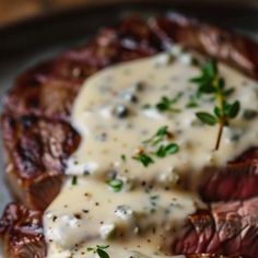 steak with gravy on a plate sitting on a table