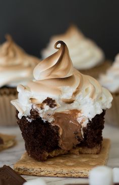 there is a chocolate cupcake with whipped cream on top