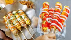 several different types of food on skewers being held by someone's hands