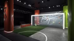 an indoor soccer field is lit up at night with neon lights and artificial grass on the ground