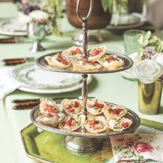 a three tiered tray with food on it