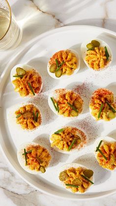 deviled eggs are arranged on a white plate