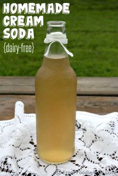 a bottle of homemade cream soda sitting on top of a doily