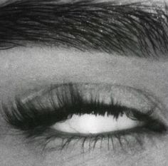 black and white photograph of an eye with long lashes