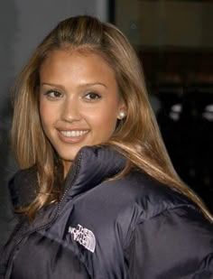 a beautiful young woman wearing a black jacket